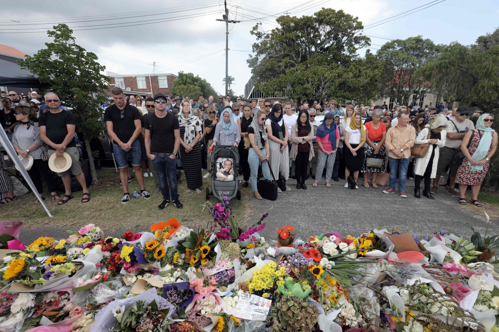 Local residents with head scarfs gather for the call to prayer and the moments silence at Masjid Umar mosque in Auckland on March 22, 2019. (Photo by Michelle Hyslop / AFP)