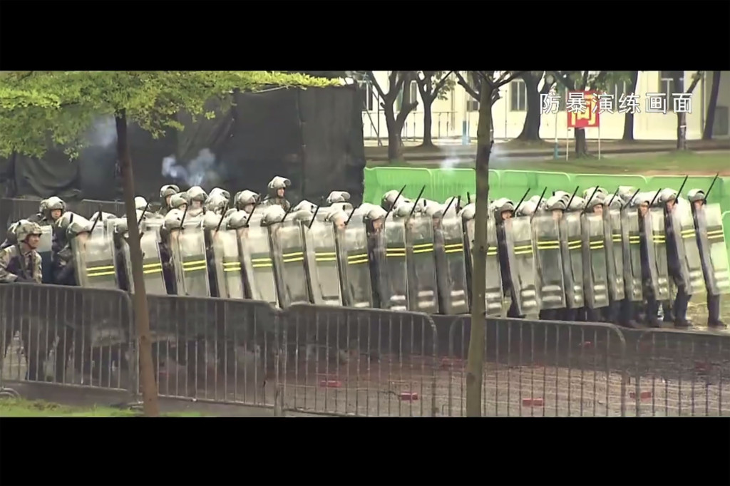 China military has released a slick propaganda video showing a drill of armed troops quelling a protest in Hong Kong (Photo by AFP) 