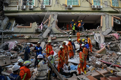 Rescue teams evacuate residents trapped under the collapsed building Sky Villa Condominium development in Mandalay, Myanmar, on March 30, 2025.Sai Aung MAIN/AFP