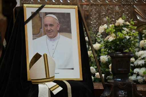  A picture of the late Pope Francis is displayed during an interfaith mass at Buenos Aires Cathedral on April 22, 2025, a day after his death. JUAN MABROMATA / AFP